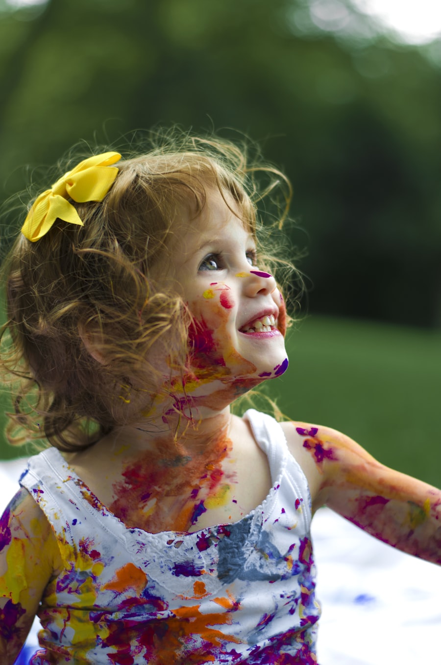 Laughing girl with craft paint on her hands at Keiki Church