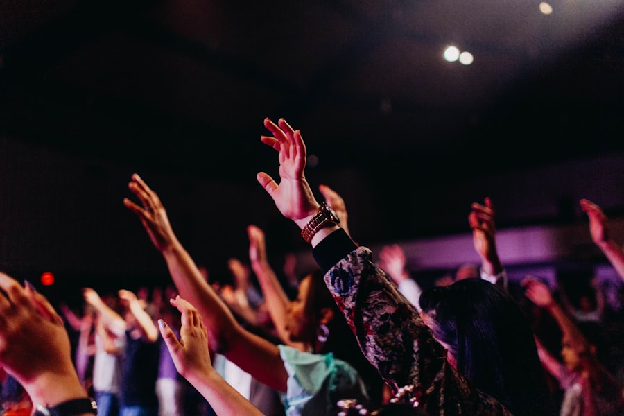 Hands raised in worship in warm morning light